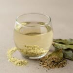 쑥 효능과 쑥가루 쑥차 활용법 및 주의사항 유리잔에 담긴 쑥가루와 쑥차, 옆에 말린 쑥잎이 놓여 있는 정물 사진